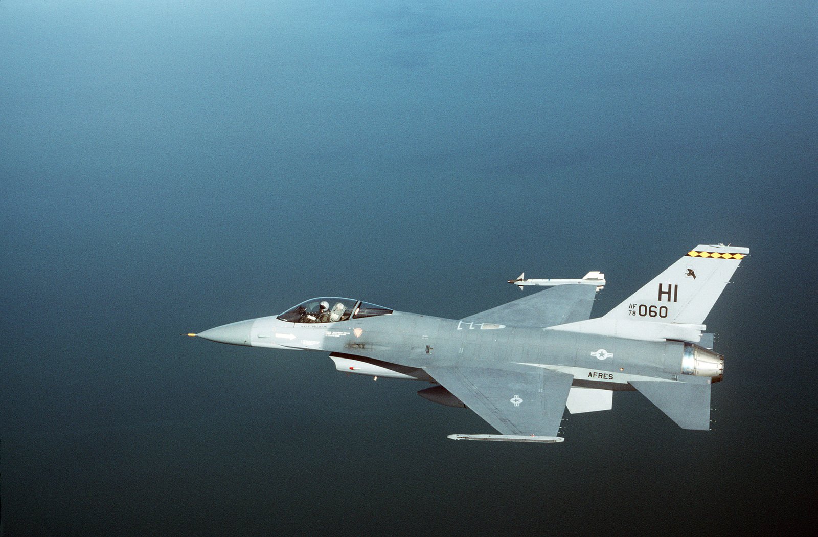 An air-to-air left side view of an F-16 Fighting Falcon aircraft of the ...