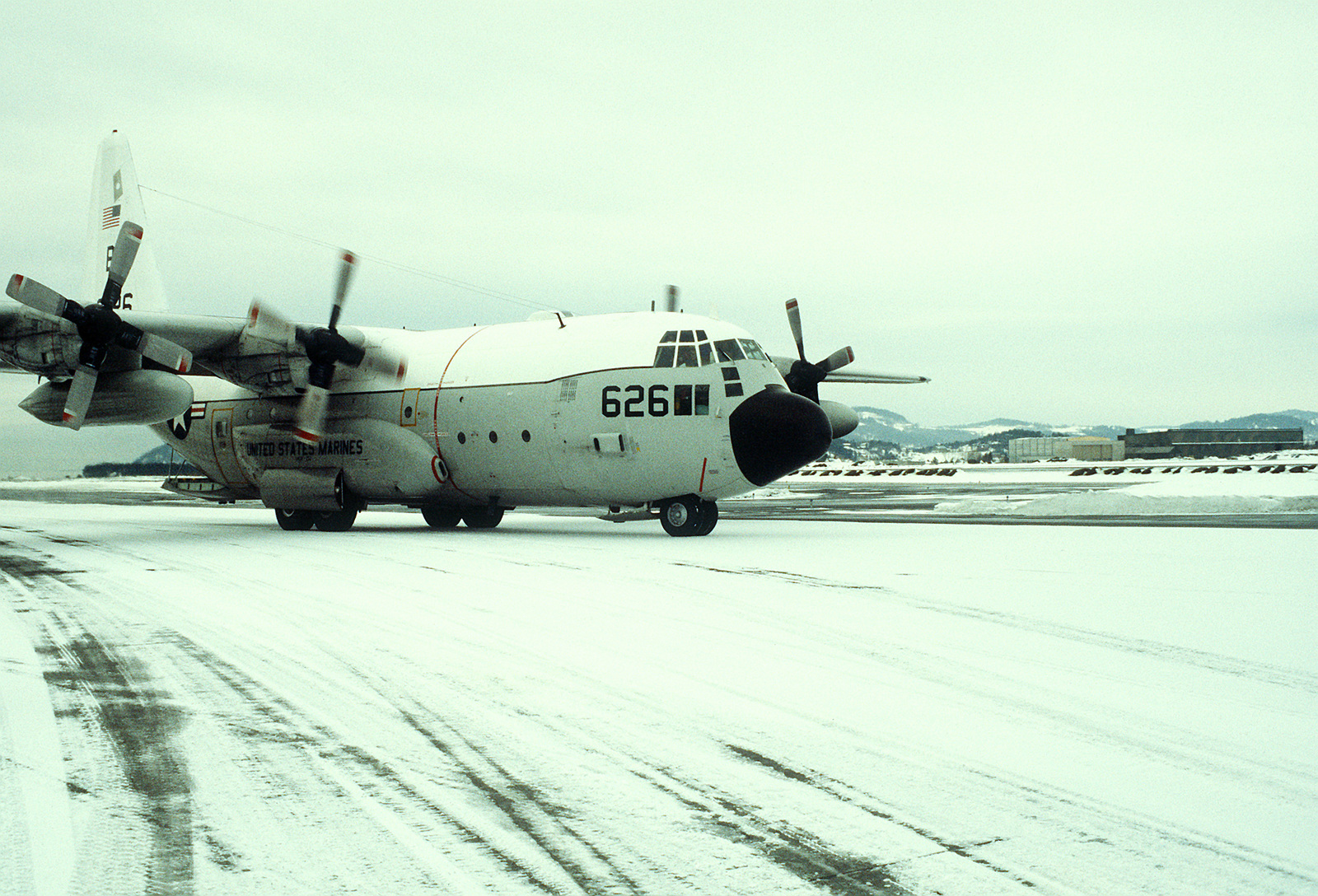 A right front view of a KC-130R Hercules aircraft taxiing along a ...