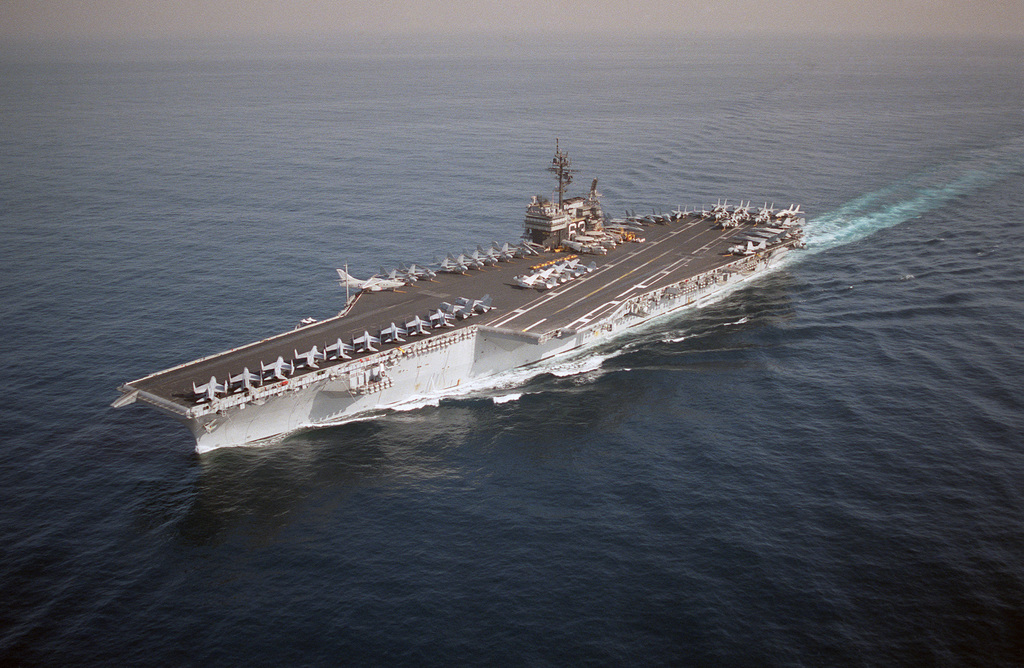 An aerial port bow view of the aircraft carrier USS KITTY HAWK (CV 63 ...