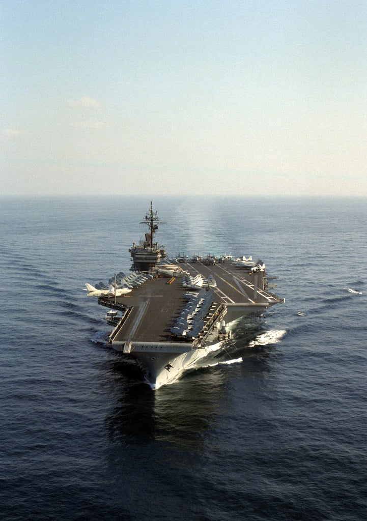 An aerial port bow view of the aircraft carrier USS KITTY HAWK (CV-63 ...