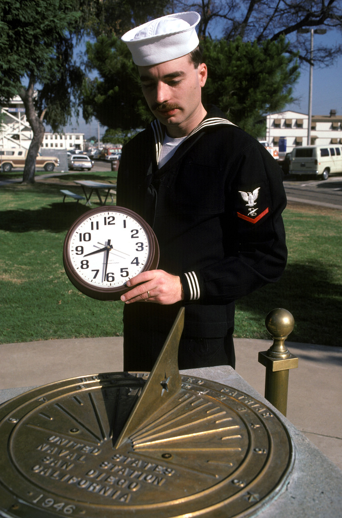 A sailor resets his clock using a sun dial to reflect the one-hour  difference between standard time and daylight-saving time - NARA & DVIDS  Public Domain Archive Public Domain Search