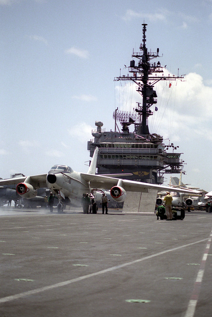 Catapult crewmen position a Fleet Air Reconnaissance Squadron (VQ-1) EA ...