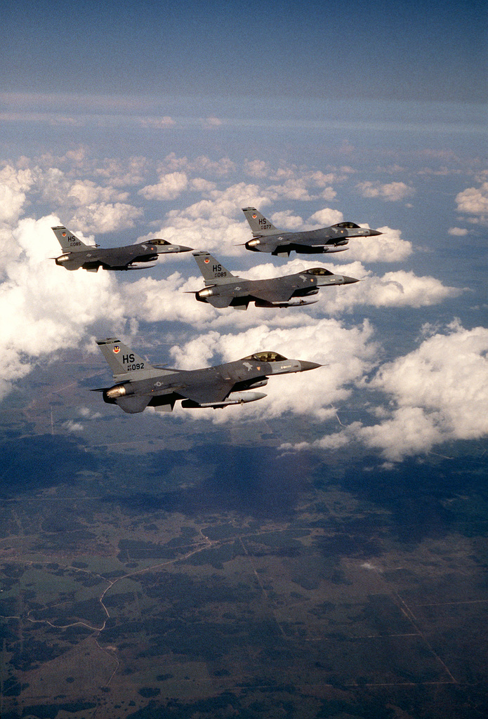 An air-to-air right view of four 308th Tactical Fighter Squadron F-16 ...