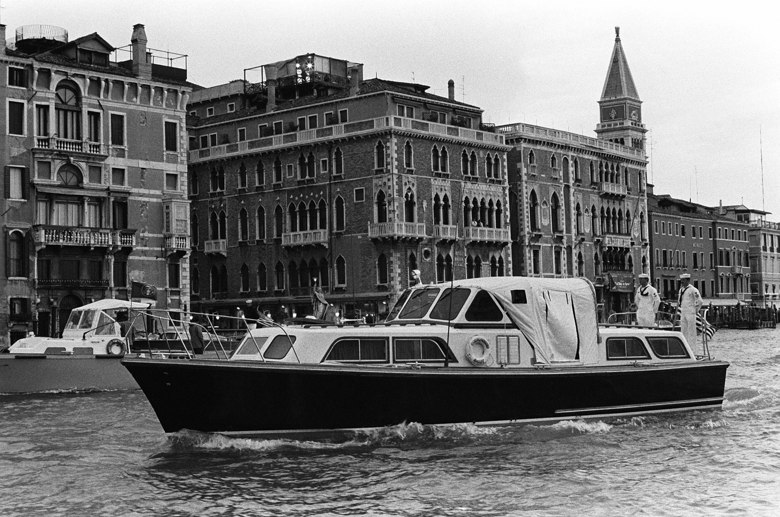 A port bow view of President Ronald's barge flanked by security vessels