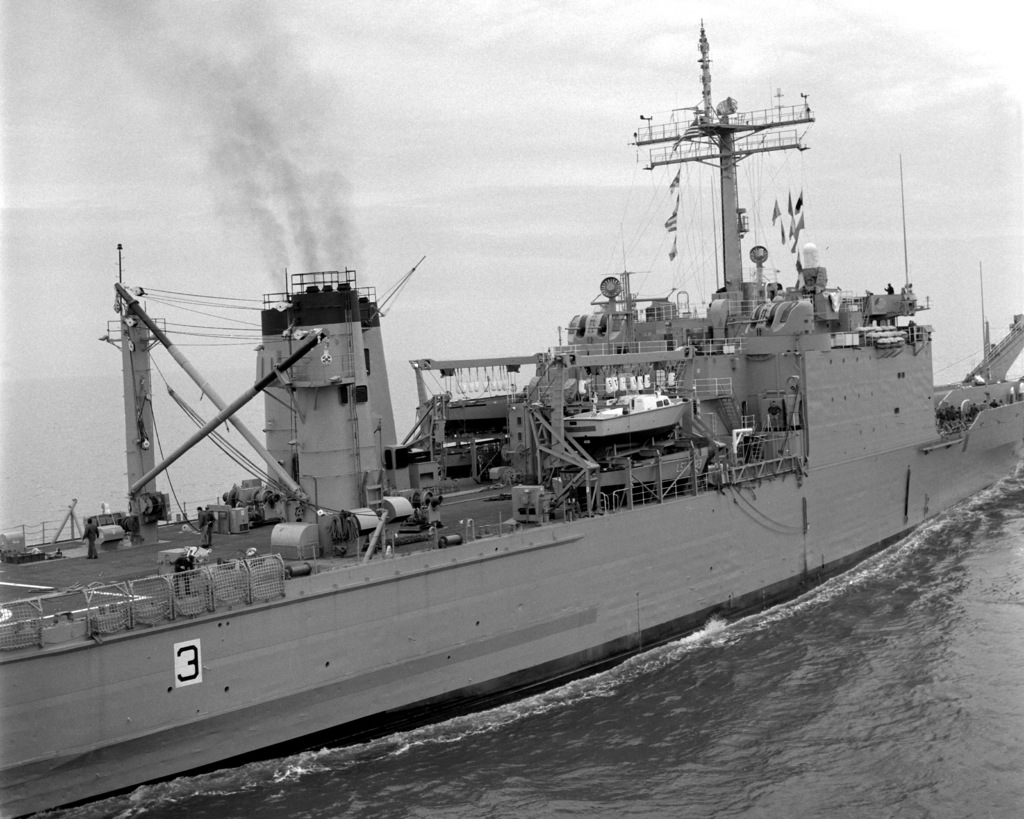 A starboard amidships view of the tank landing ship USS BARNSTABLE ...