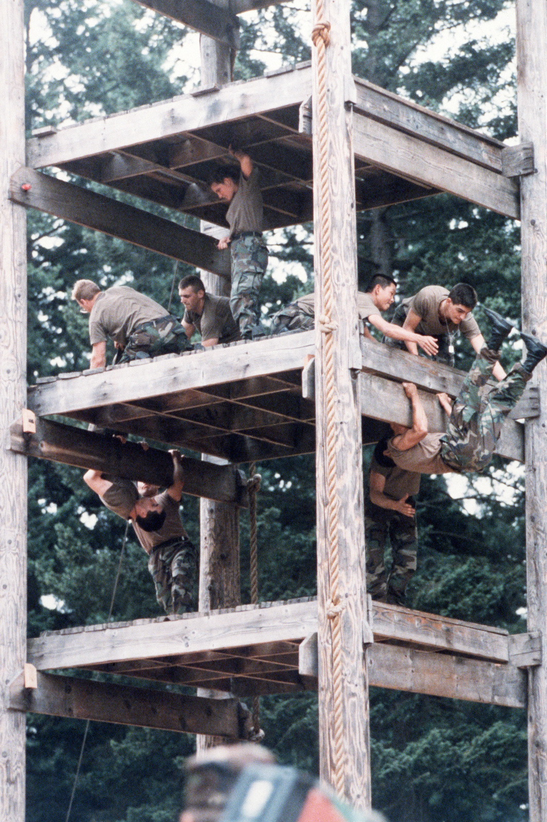 Cadets climb a tower on the obstacle course during the 4th Army ROTC