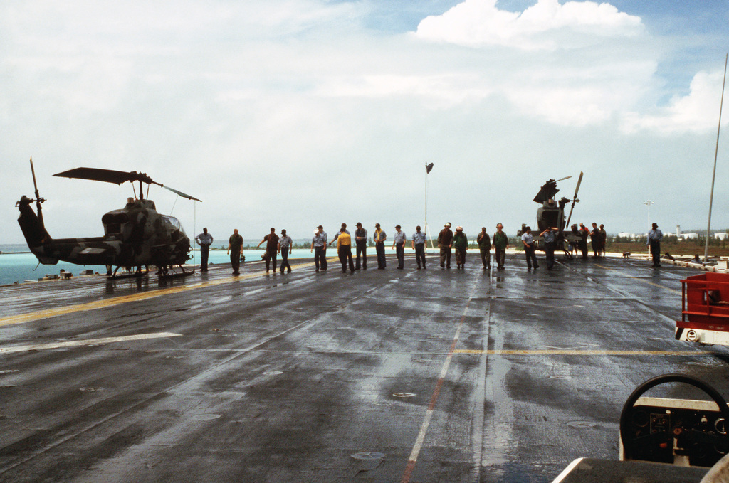 Crew members execute a foreign object damage walk-down on the flight ...