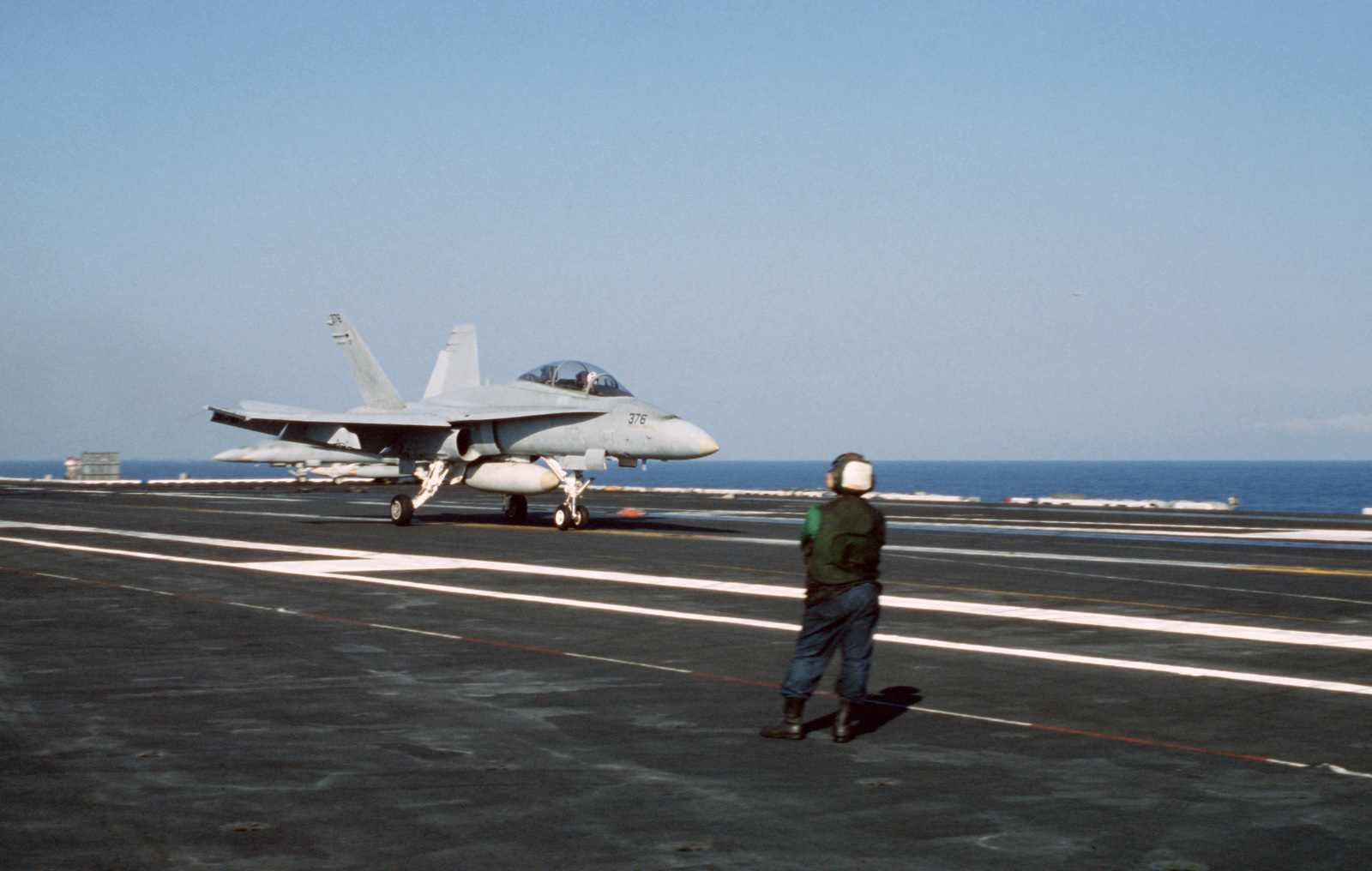 A Strike-Fighter Squadron 106 (VFA-106) TF/A-18 Hornet aircraft lands ...