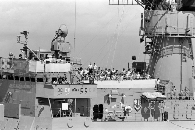 Crewman gather at the rail of the frigate USS MEYERKORD (FF 1058 ...