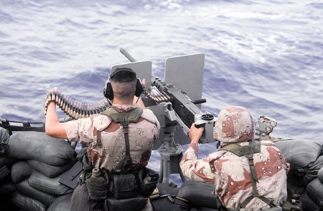 Members of the Marine Detachment fire an M-2 .50-caliber machine gun ...