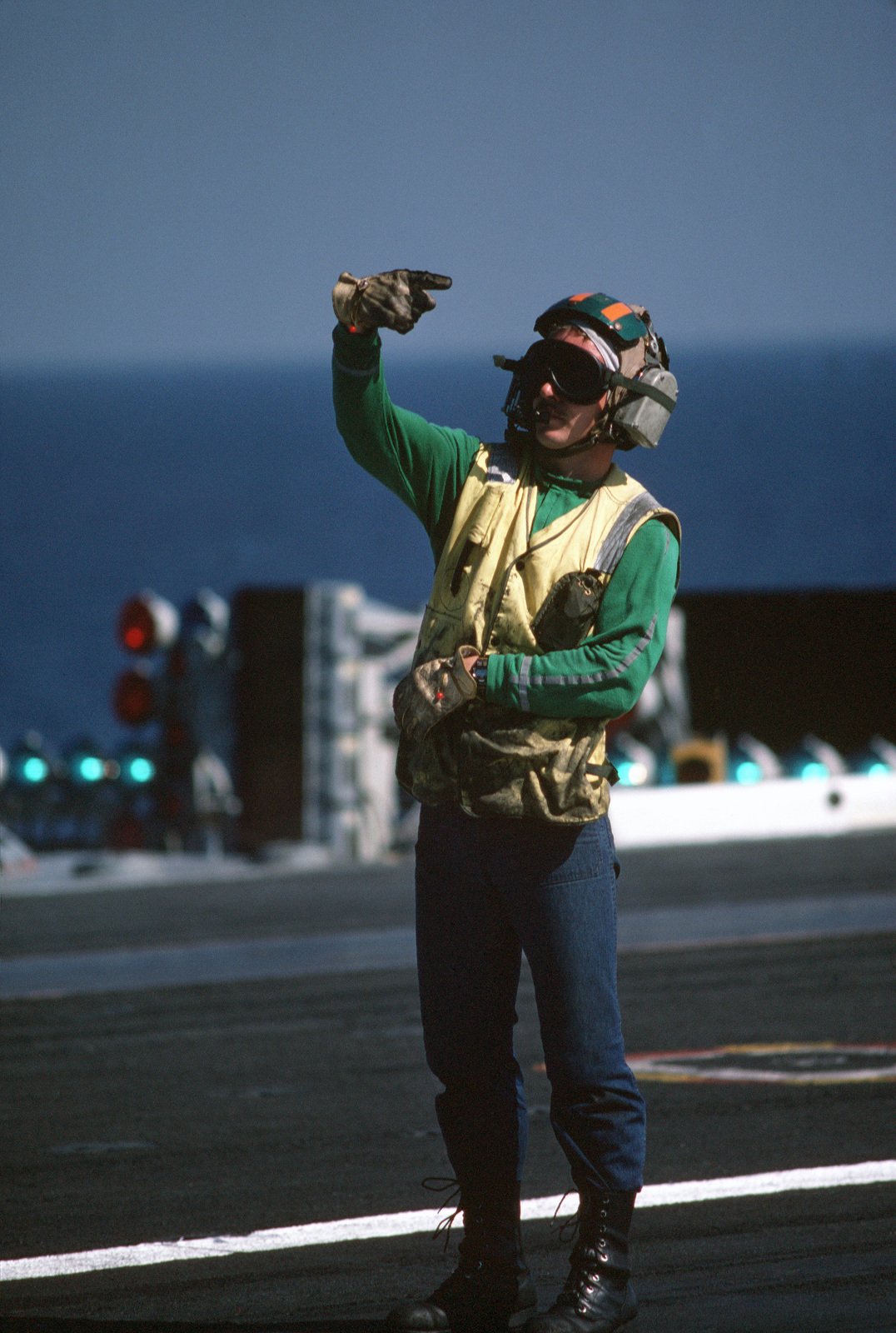 A Catapult And Arresting Gear Crewman Signals Instructions During Flight Operations Aboard The