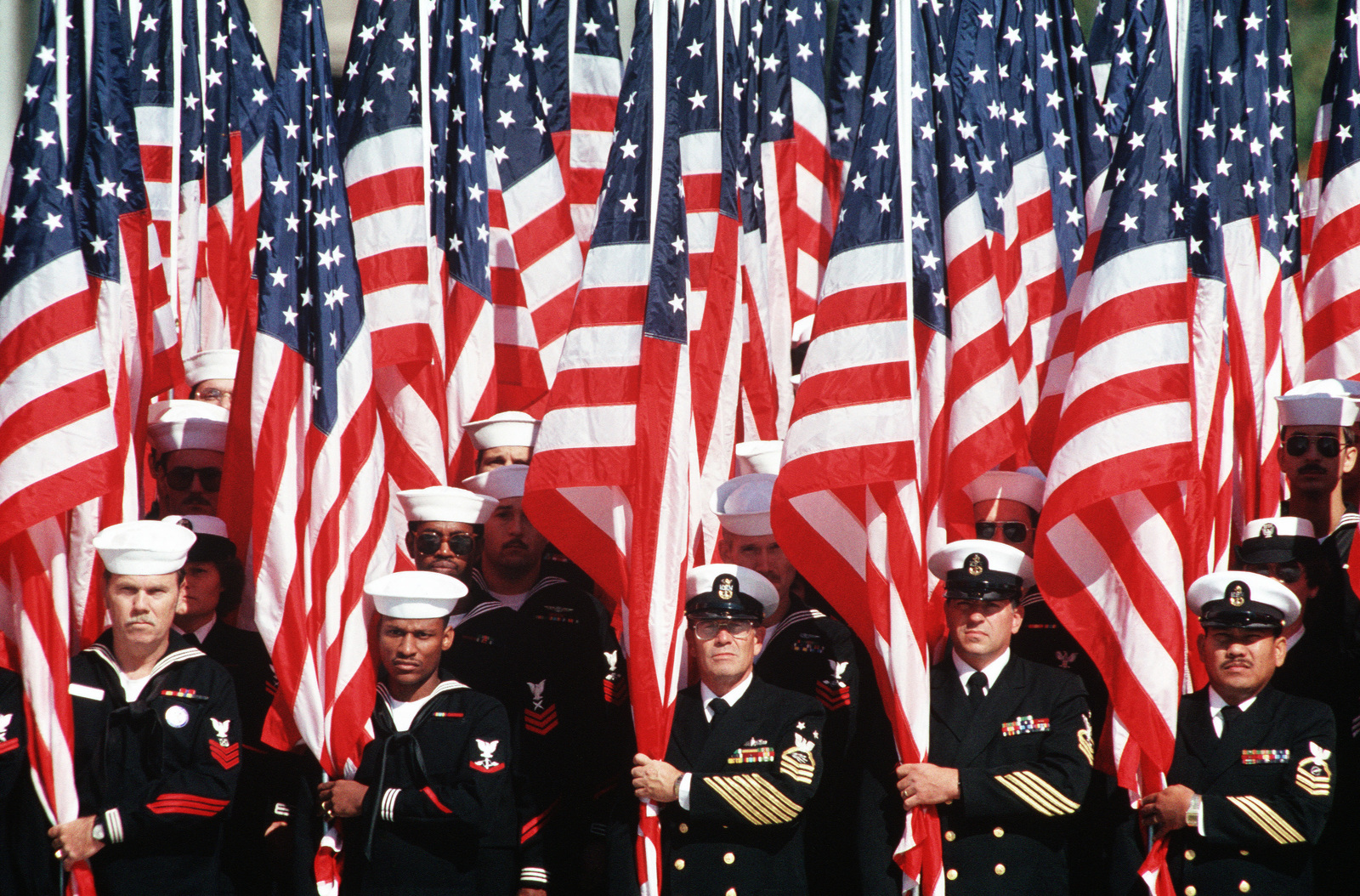 navy-personnel-hold-a-bevy-of-us-flags-during-the-dedication-ceremonies