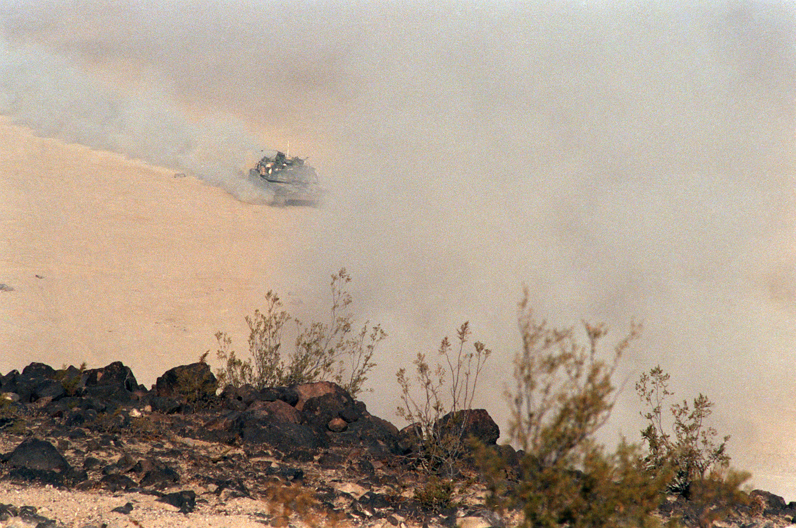 An M1A1 Abrams Main Battle Tank Maneuvers Through A Smoke Screen During ...