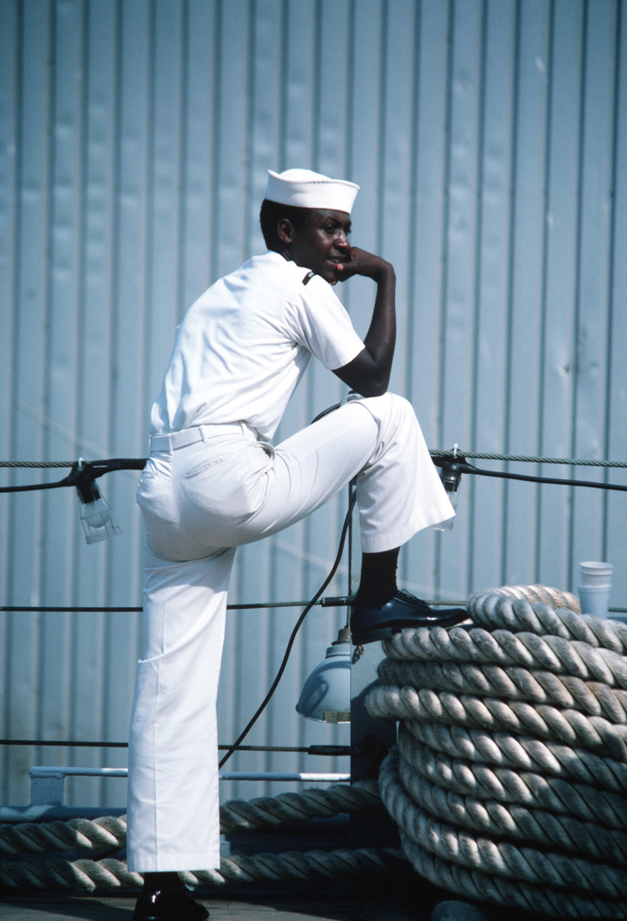 A Sailor Takes A Break Aboard The Battleship USS IOWA (BB 61) While The ...