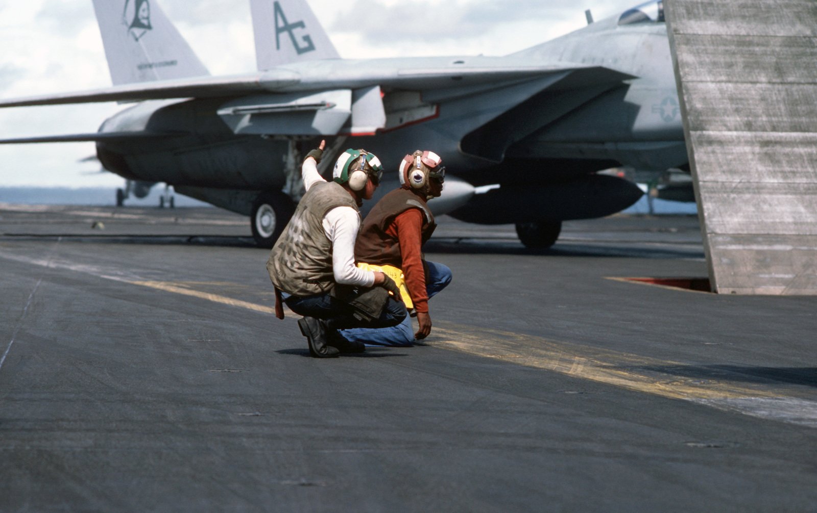 A Flight Deck Crewman Gives The Thumbs Up Signal During Flight