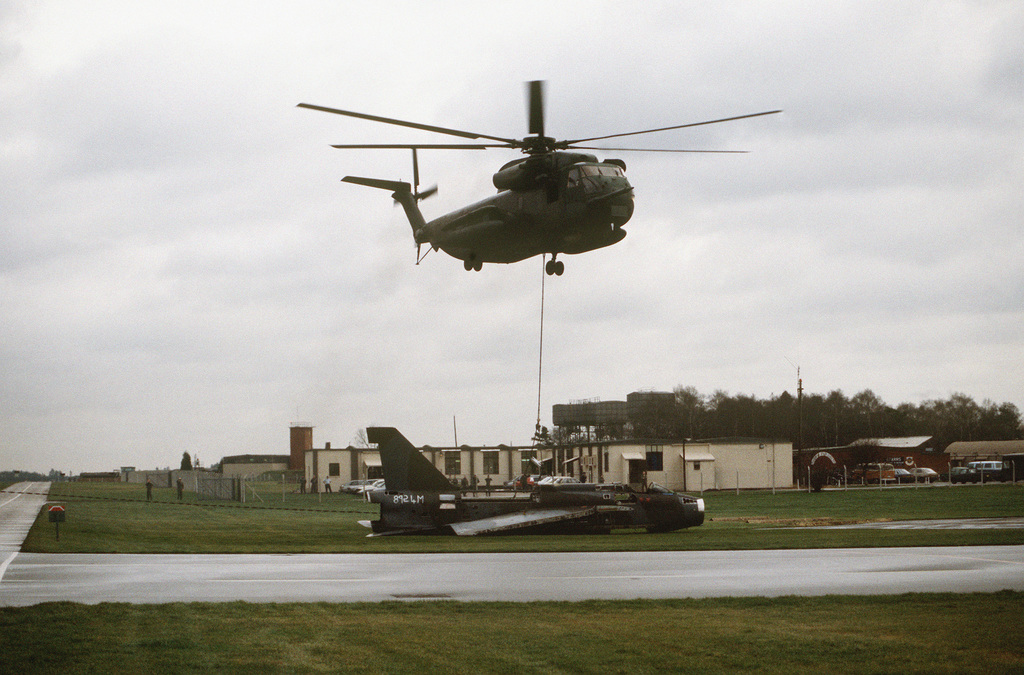 A HH-53B Super Jolly Helicopter Prepares To Lift An Old British Fighter ...