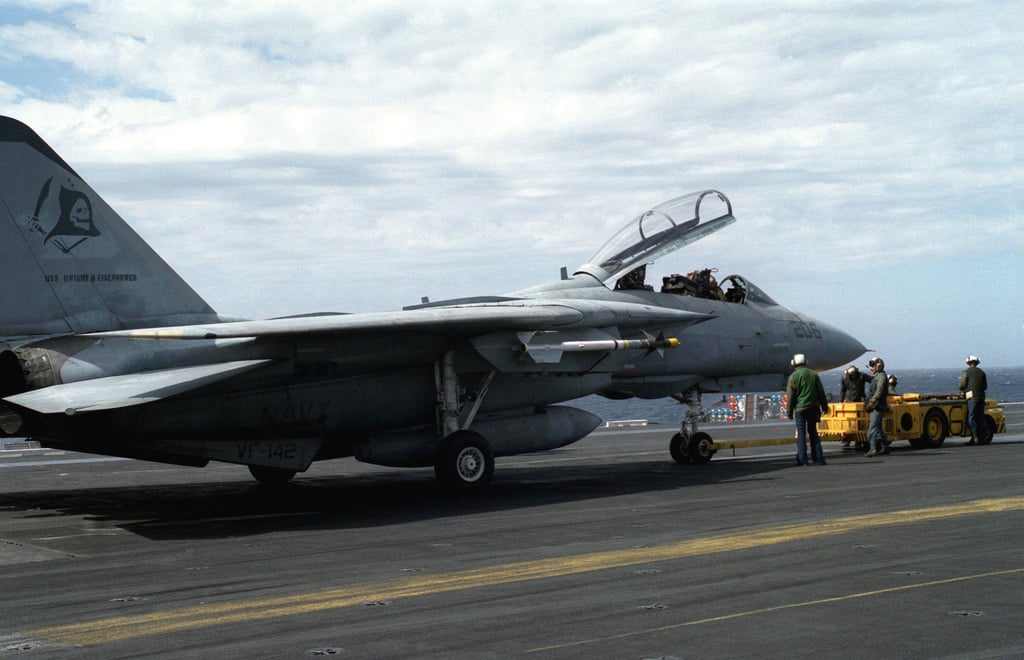 Aircraft handlers use an MD-3A tow tractor to move a Fighter Squadron ...