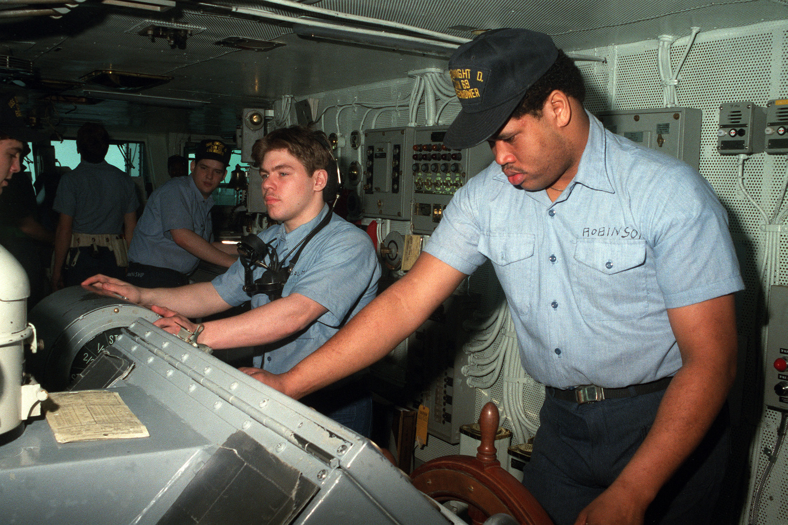 A view of helmsmen at work on the bridge of the US Navy (USN) Nuclear ...