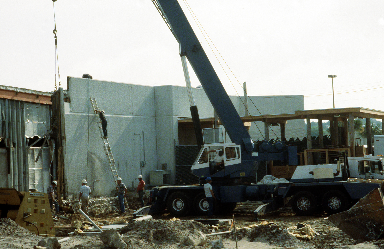 Civilian contractors work at the site of the new brig under ...