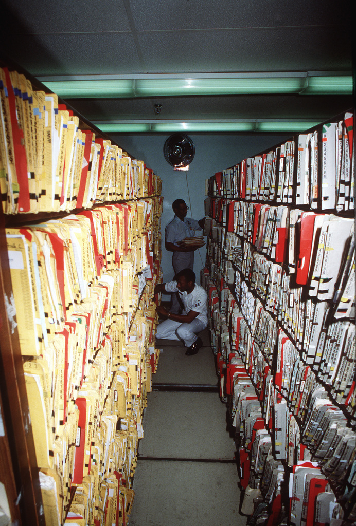 a-hospital-corpsman-and-a-civilian-employee-file-medical-records-at-the