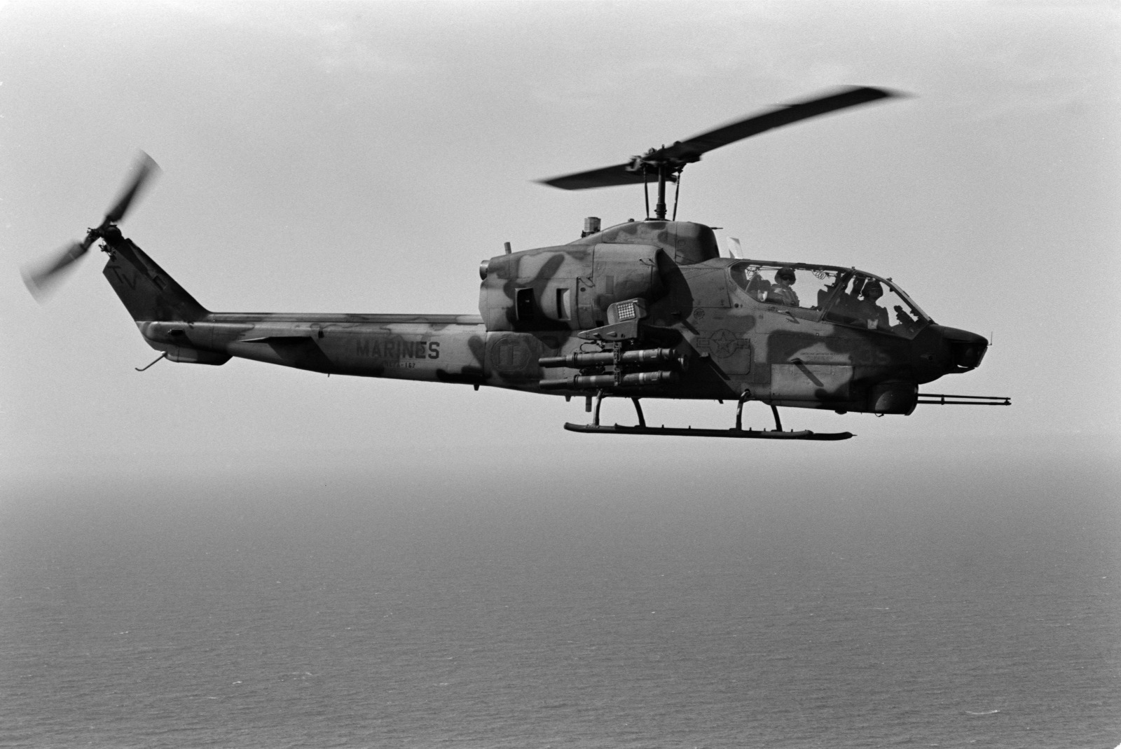 An air-to-air right side view of an AH-1 Sea Cobra helicopter from ...