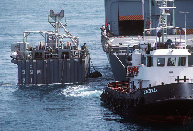 A Civilian Tug Maneuvers The Guided Missile Frigate USS SAMUEL B ...