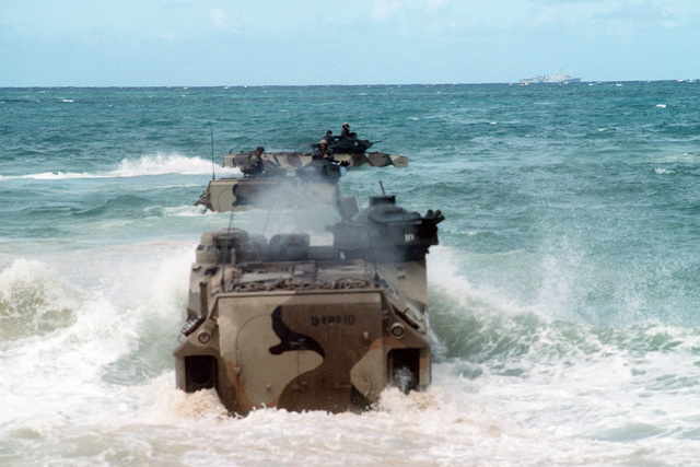 Three AAVP-7 Assault Amphibian Vehicles (AAVs) enter the surf as they ...