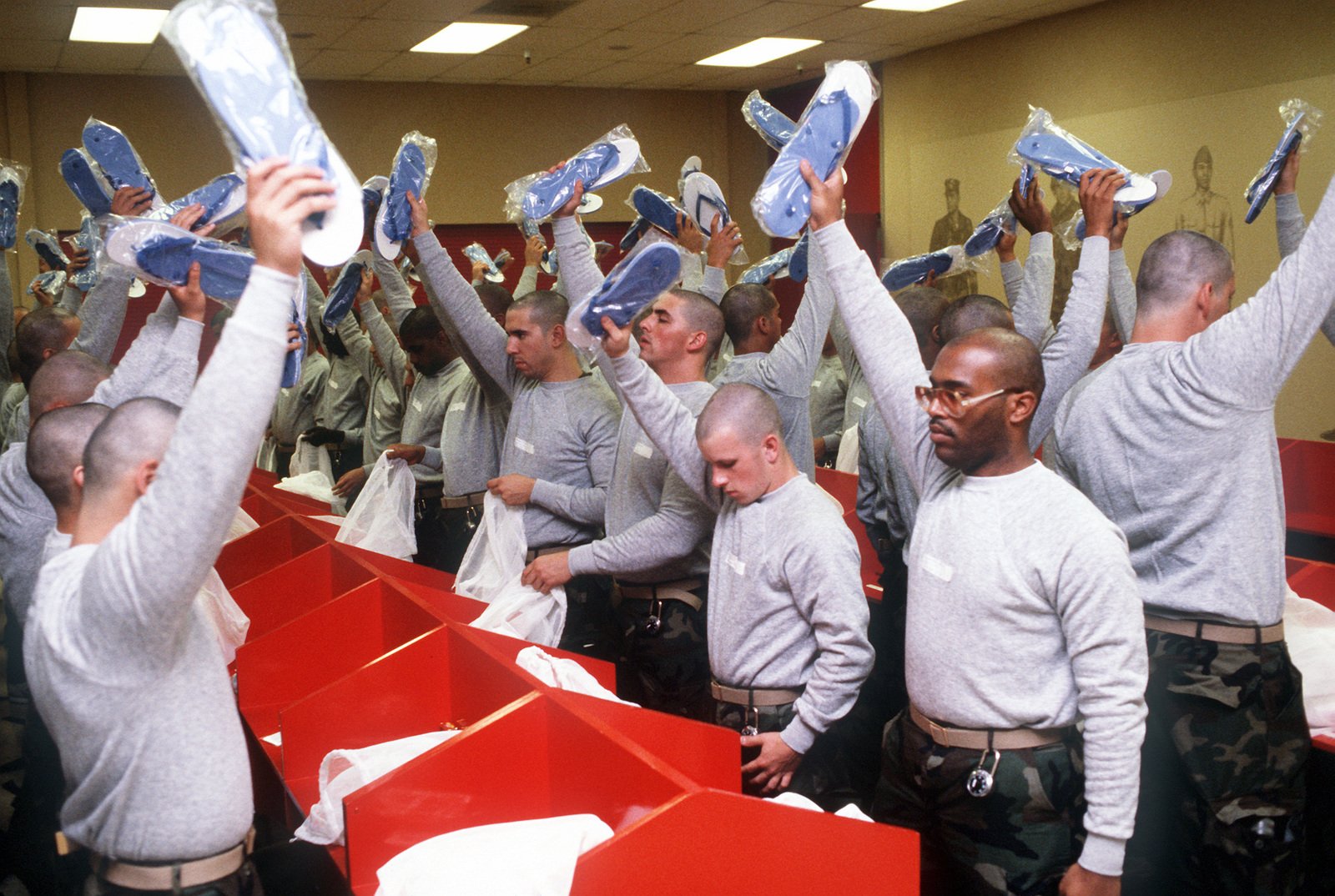 Marine Corps recruits inspect their uniform issue during in-processing ...