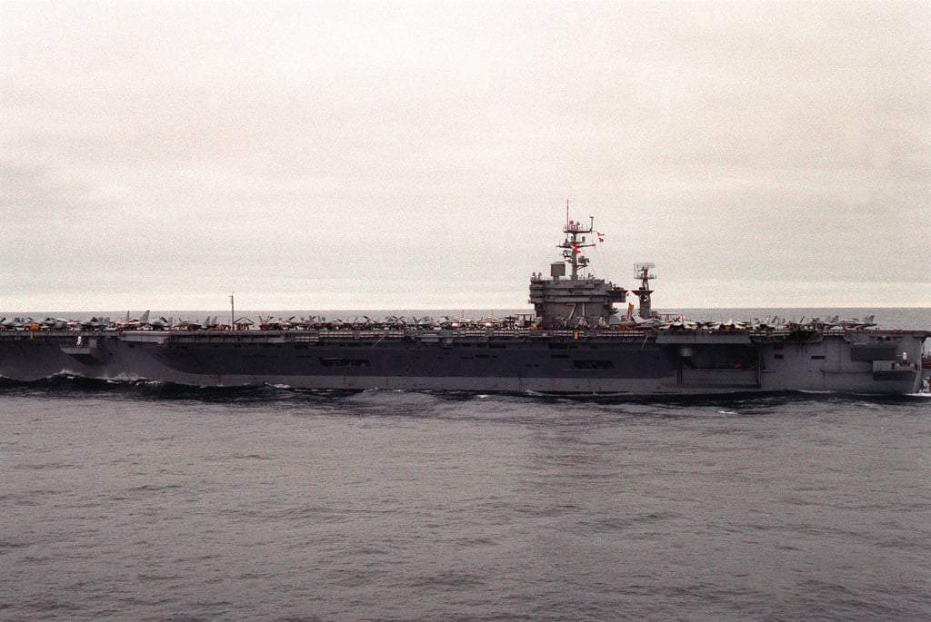 A port beam view of the nuclear-powered aircraft carrier USS THEODORE ...