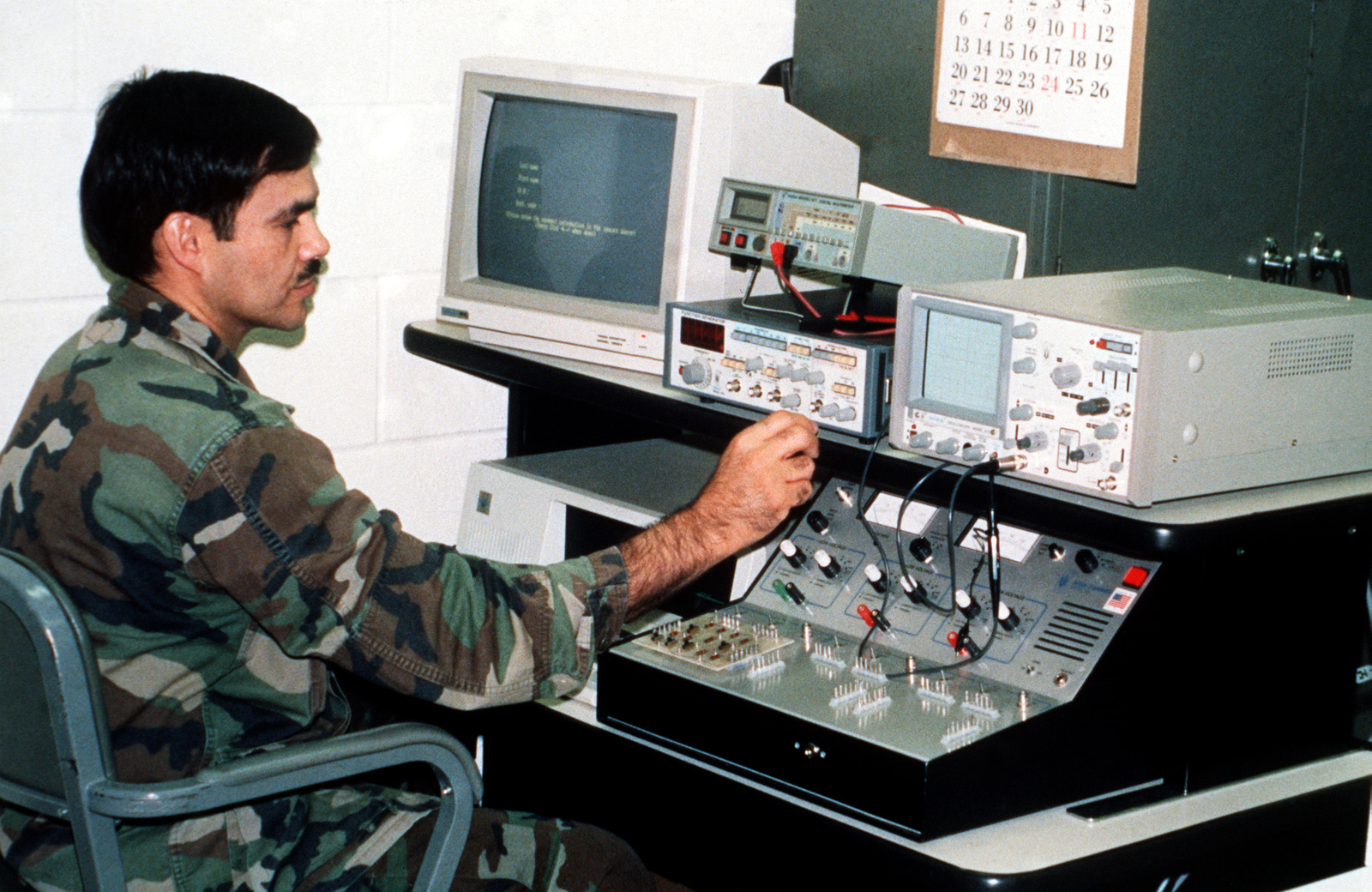 An instructor at the US Army Signal School uses a personal computer and an artificial language