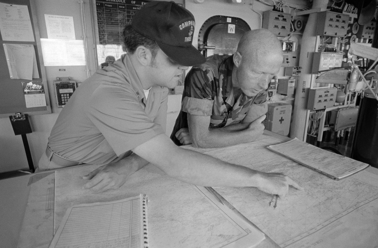 a-chief-petty-officer-discusses-ship-navigation-with-a-marine-on-the