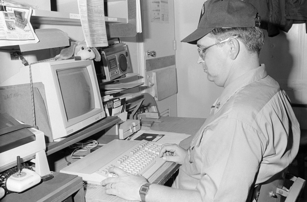 a-chief-petty-officer-works-at-a-computer-workstation-aboard-the