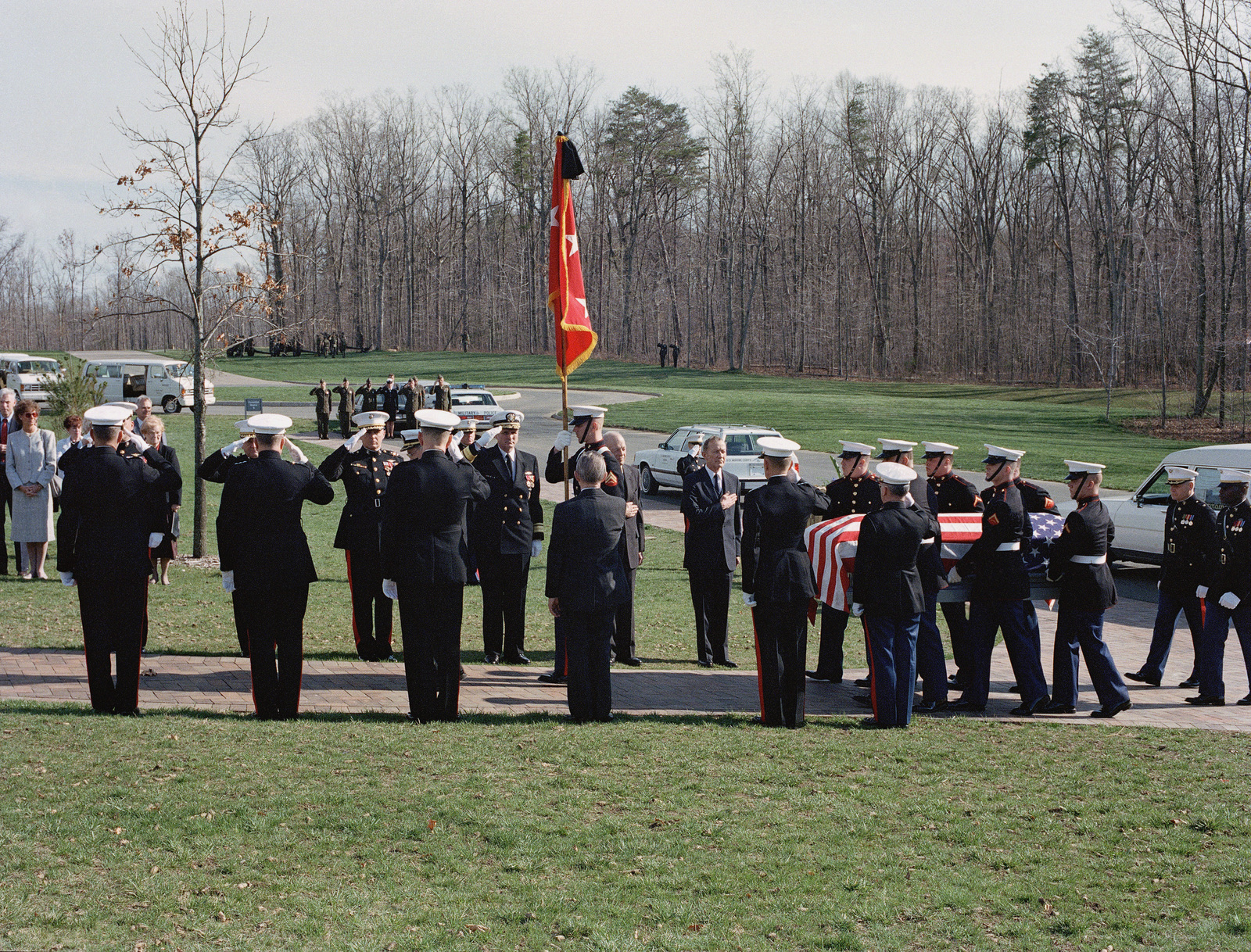 Marine officers render honors as the casket is carried to the gravesite ...