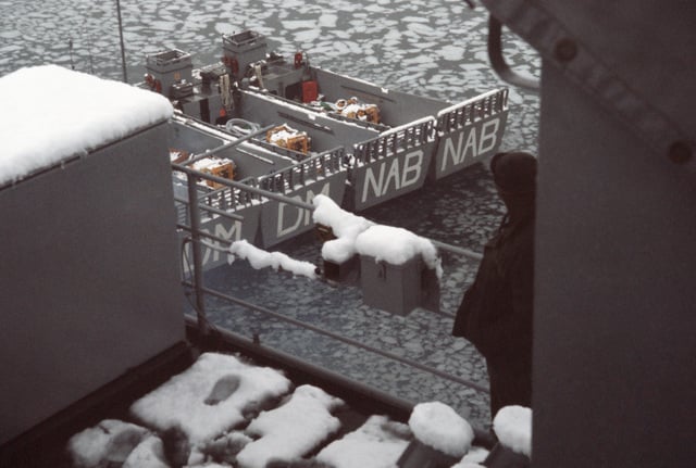 a-light-snow-covers-the-weather-decks-of-the-dock-landing-ship-uss