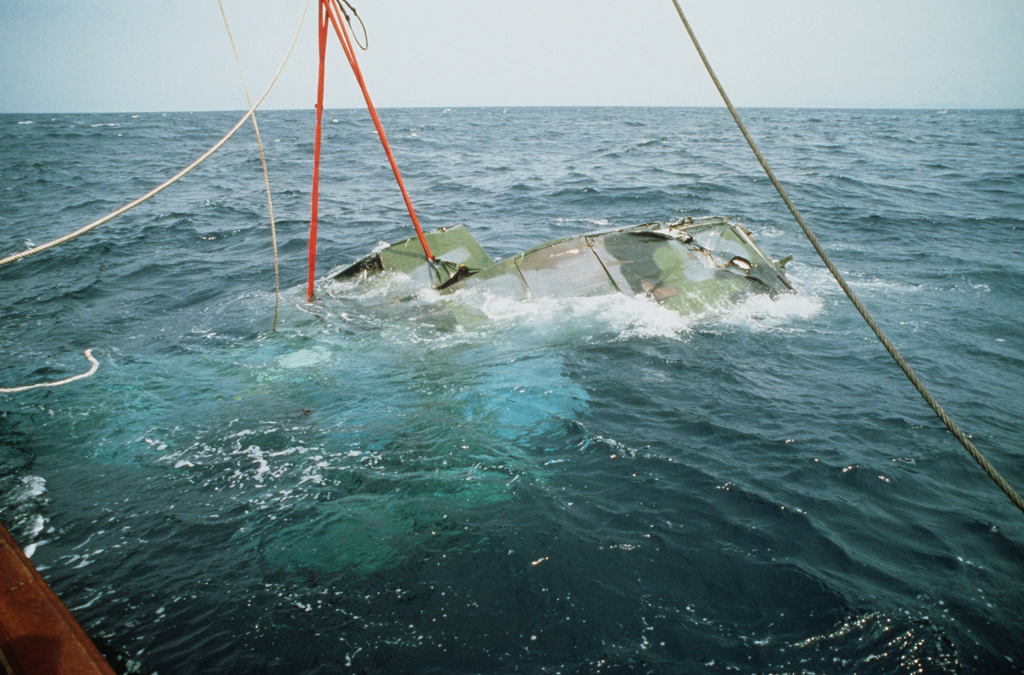 Being lifted from the depths by cranes aboard the Japanese salvage