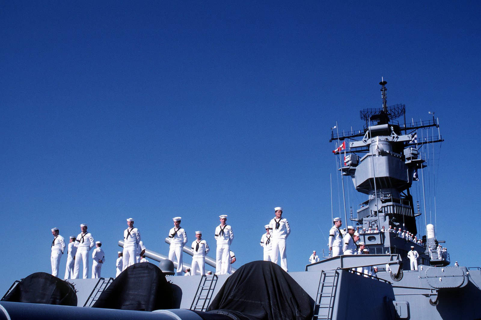 Crew Members Stand Atop The 16 Inch Gun Turret Aboard The Battleship Uss Iowa Bb 61 As The