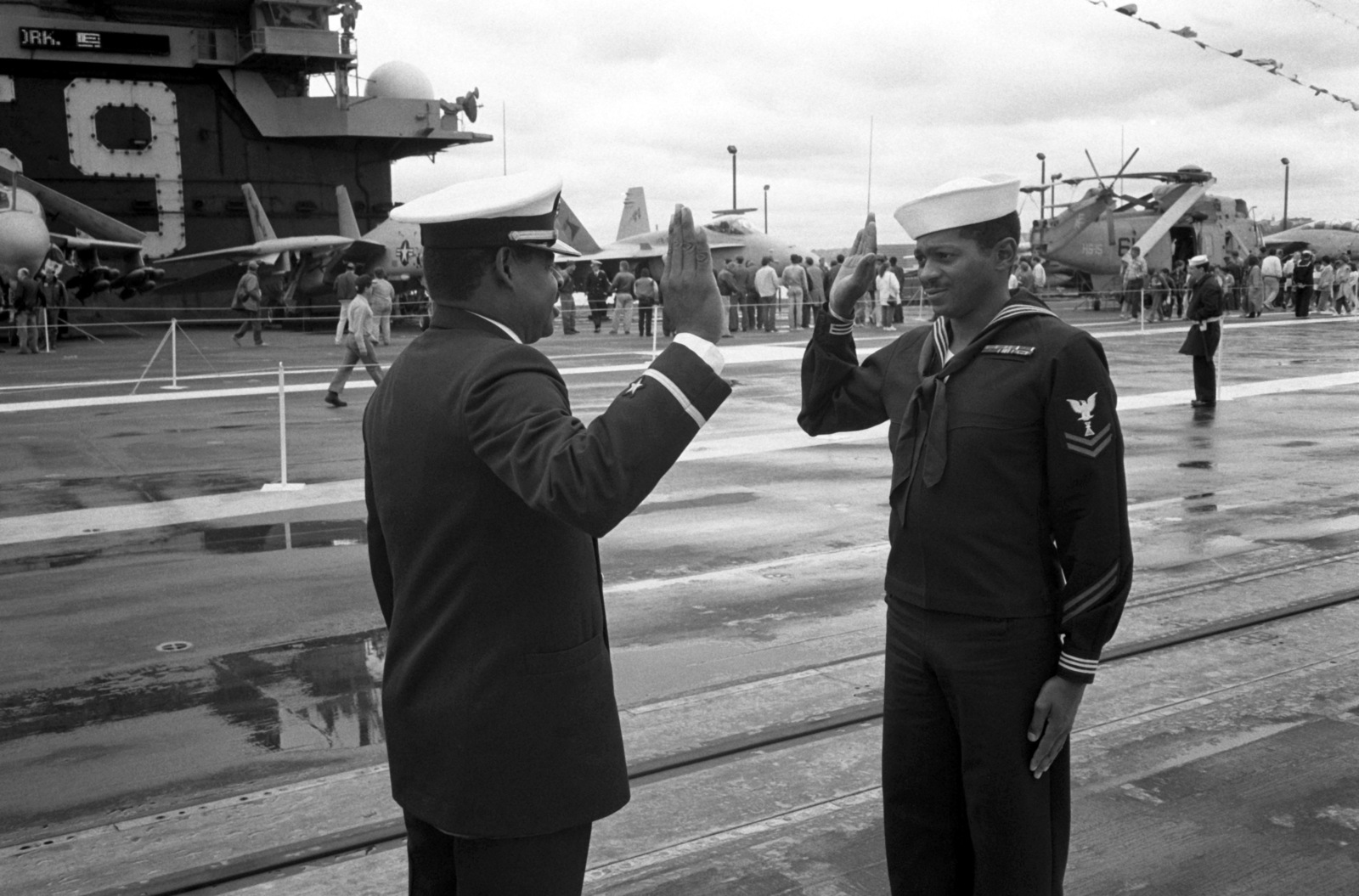 a-sailor-takes-his-re-enlistment-oath-on-the-flight-deck-of-the