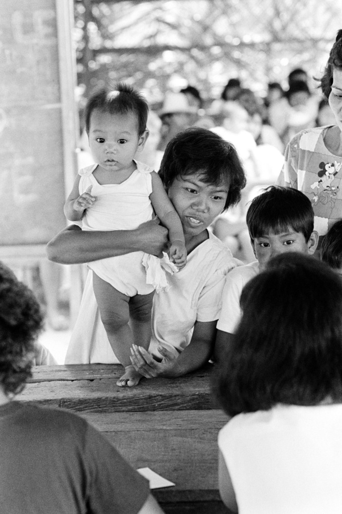 a-filipino-woman-brings-her-child-to-a-clinic-for-a-checkup-during-a