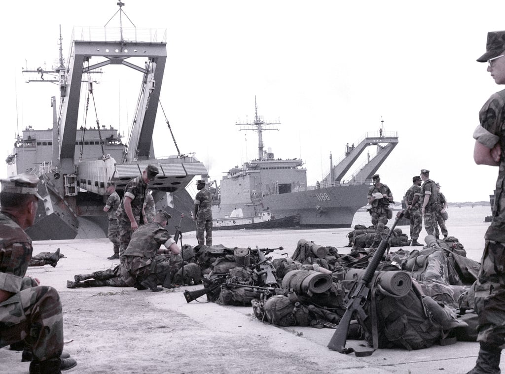 The tank landing ship USS SAGINAW (LST 1188), right, arrives at the ...