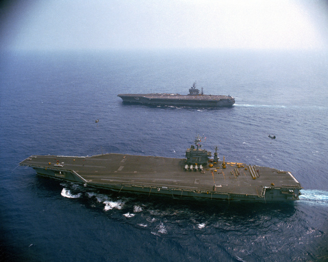 An aerial port beam view of the nuclear-powered aircraft carriers USS ...