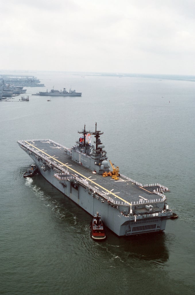 Large harbor tugs maneuver the Amphibious Assault Ship USS WASP (LHD 1 ...