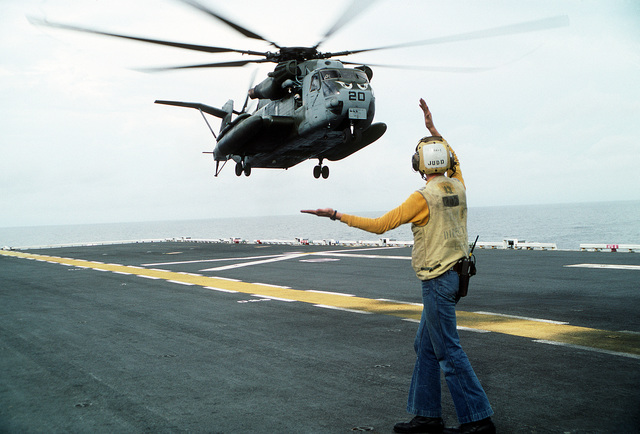 A flight deck director aboard the amphibious assault ship USS TARAWA ...