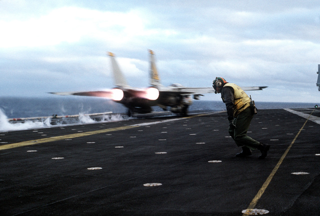 A Fighter Squadron 21 (VF-21) F-14A Tomcat aircraft is launched from ...