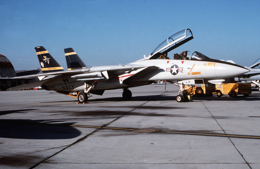 An F-14A Tomcat aircraft of Fighter Squadron 124 (VF-124) is serviced ...