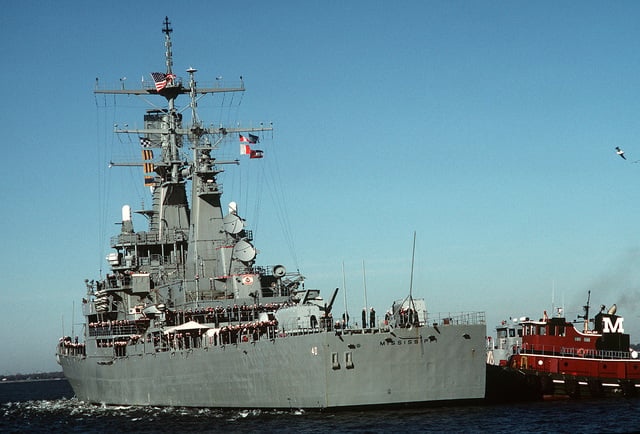 A tug helps the nuclear-powered guided missile cruiser USS MISSISSIPPI ...