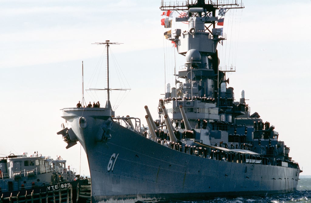 A port bow view of the battleship USS IOWA (BB 61) with crew members ...