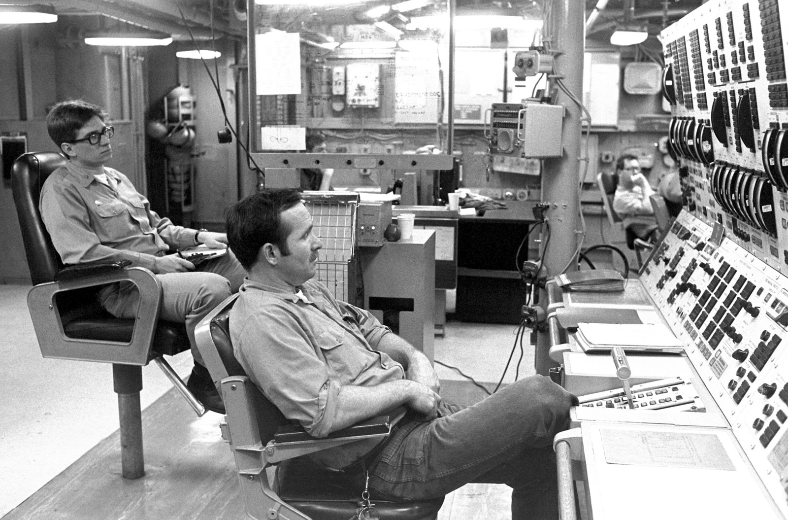 Crew members monitor the engine control panel in the central control ...