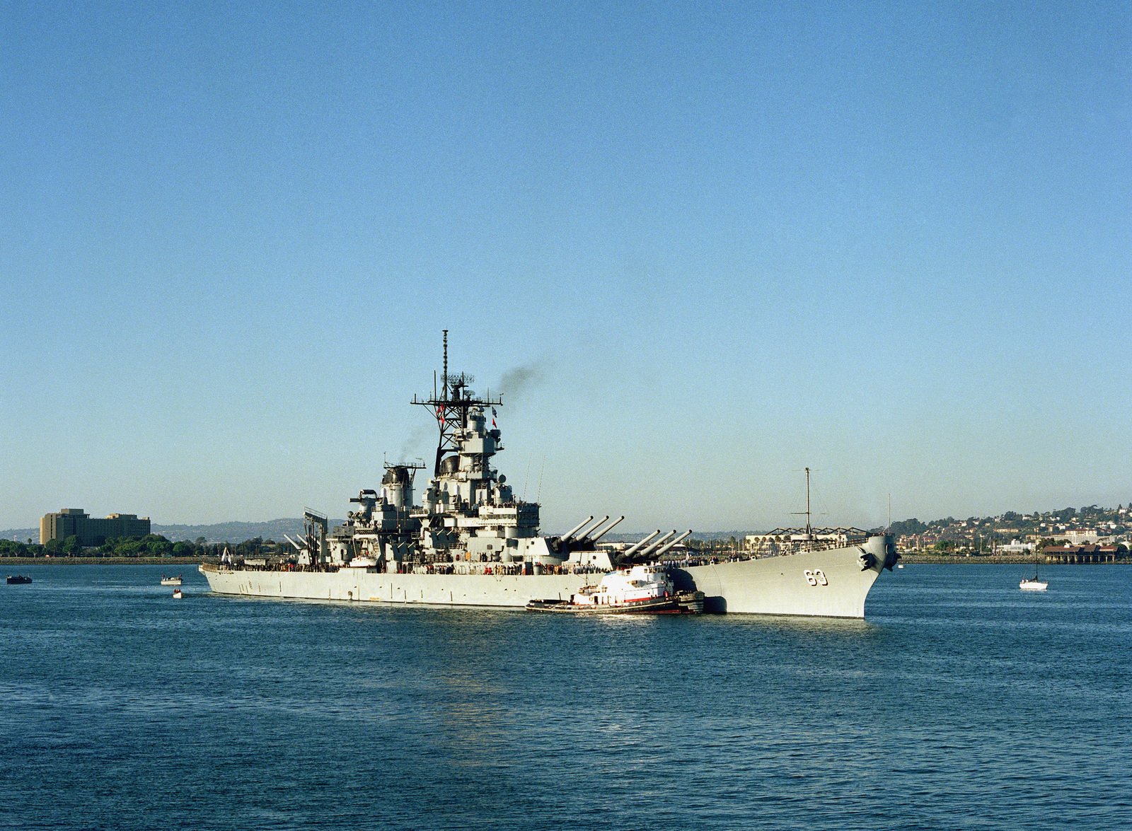 A commercial tug escorts the battleship USS MISSOURI (BB 63) as the ...