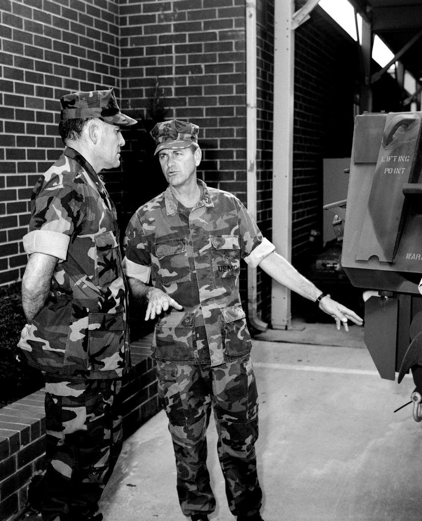 GEN. Walter E. Boomer, assistant commandant of the Marine Corps, converses  with a Marine officer aboard the amphibious transport dock USS TRENTON  (LPD-14) following his arrival on base to observe a special