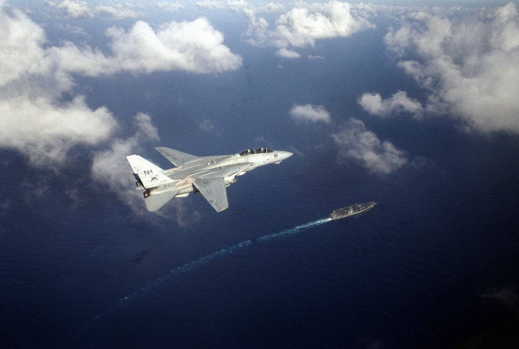 A Fighter Squadron 213 (VF-213) F-14A Tomcat aircraft flies over the ...